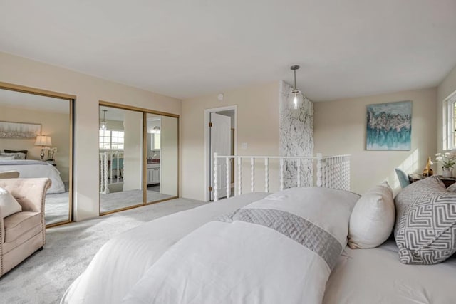 bedroom with carpet floors and two closets