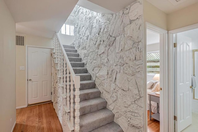 staircase with wood-type flooring