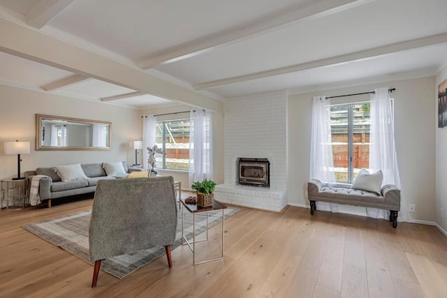 living room featuring a fireplace, beam ceiling, and light wood-type flooring