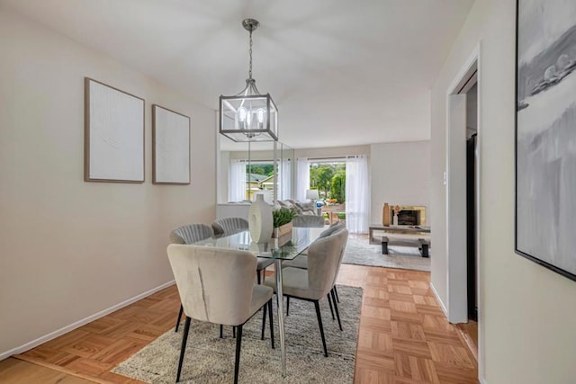 dining room featuring light parquet floors and a chandelier