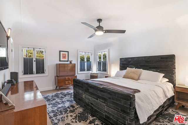 bedroom featuring hardwood / wood-style flooring and ceiling fan