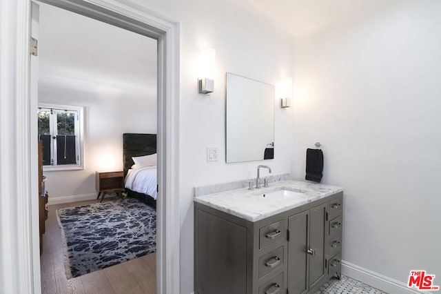 bathroom with vanity and hardwood / wood-style flooring