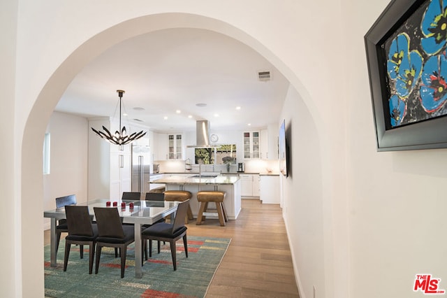 dining area featuring an inviting chandelier and light hardwood / wood-style floors