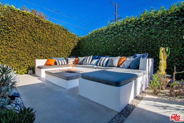 view of patio / terrace featuring an outdoor living space with a fire pit