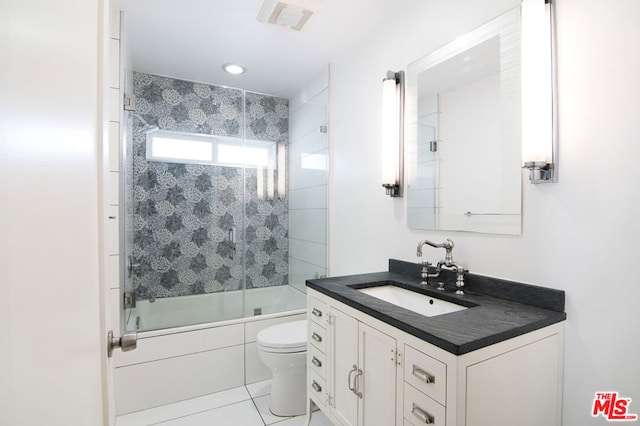 full bathroom featuring enclosed tub / shower combo, vanity, tile patterned floors, and toilet