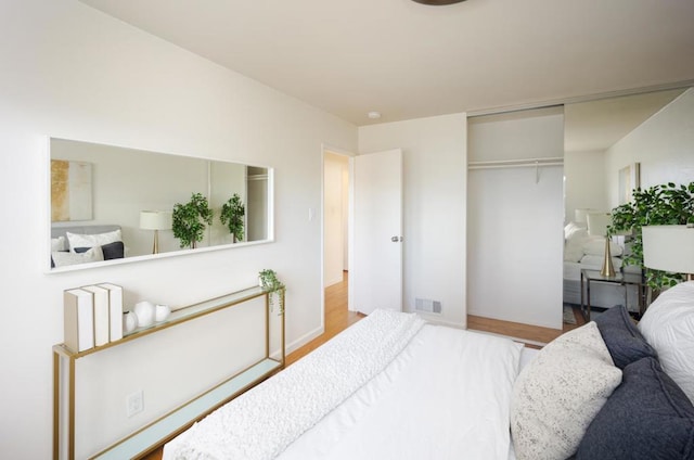 bedroom featuring a closet and light wood-type flooring