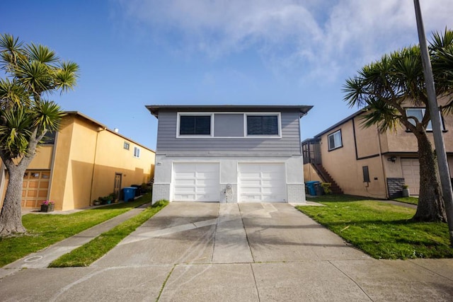 view of front of house with a garage and a front lawn