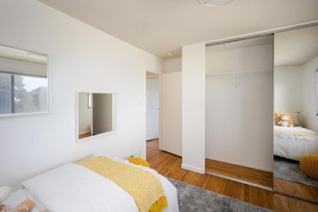 bedroom with hardwood / wood-style flooring and a closet