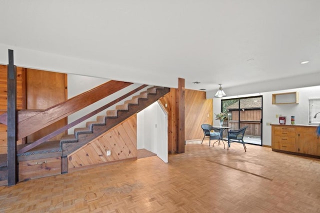 interior space featuring light parquet floors and wood walls