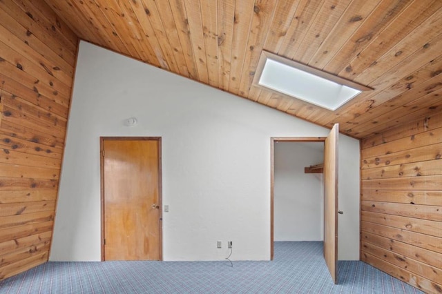 additional living space featuring wood ceiling, wood walls, vaulted ceiling with skylight, and carpet flooring