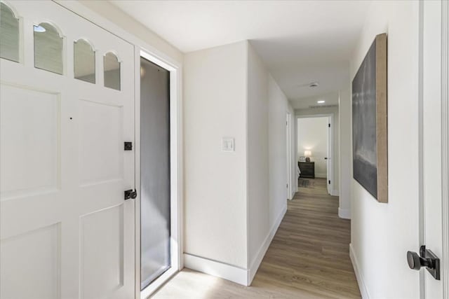 corridor with light wood-type flooring