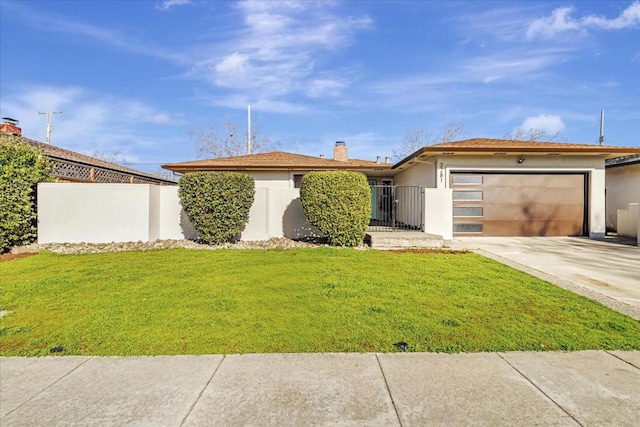 view of front of property featuring a garage and a front lawn