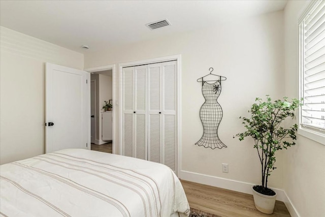 bedroom with wood-type flooring and a closet