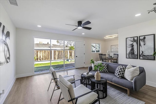 living room featuring hardwood / wood-style flooring and ceiling fan