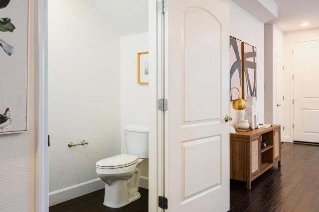 bathroom featuring hardwood / wood-style flooring and toilet