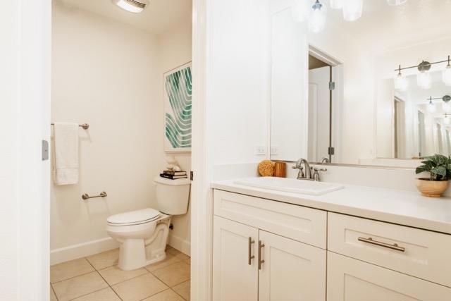 bathroom with tile patterned floors, toilet, and vanity