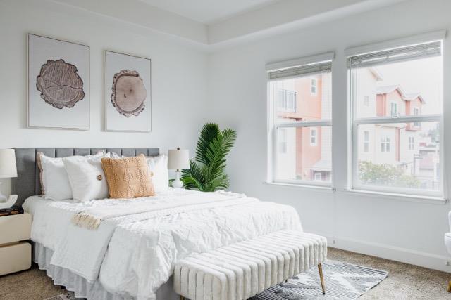 bedroom with multiple windows and carpet flooring