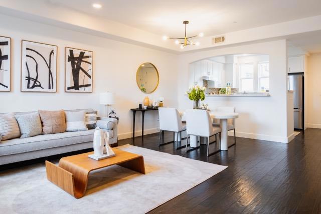 living room featuring a chandelier and dark hardwood / wood-style flooring