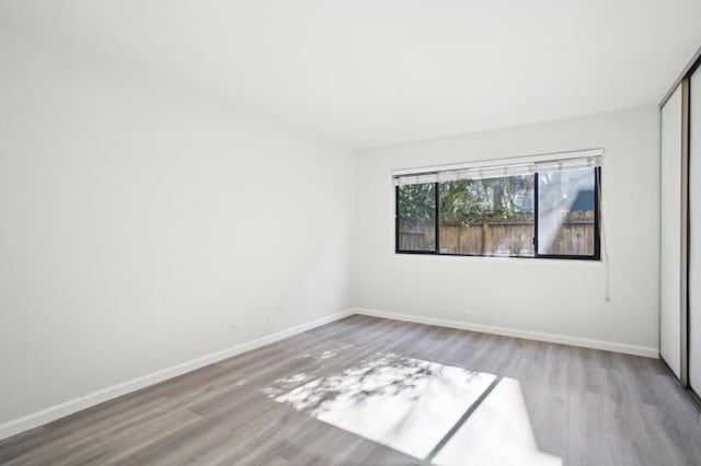 unfurnished room with light wood-type flooring