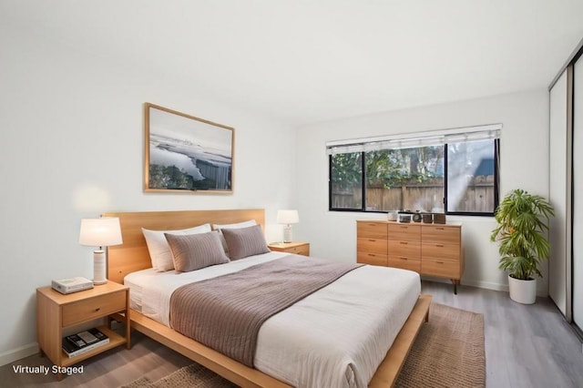 bedroom with hardwood / wood-style flooring