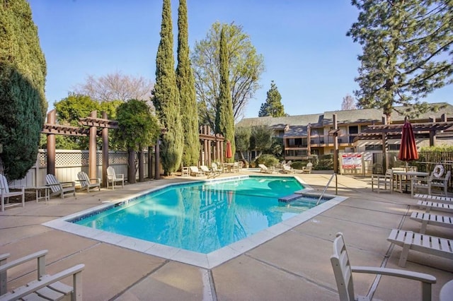 view of swimming pool with a pergola and a patio