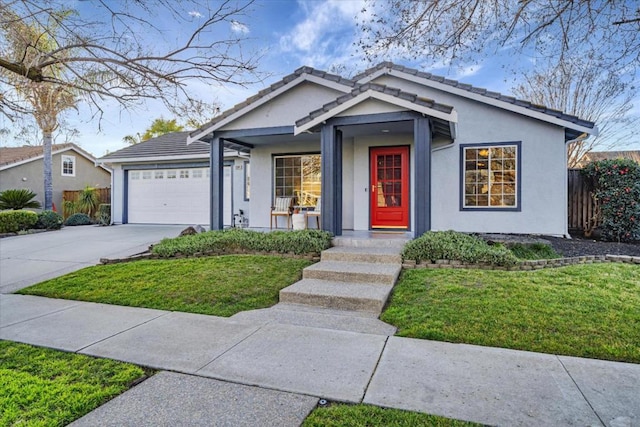 view of front of home with a garage and a front lawn