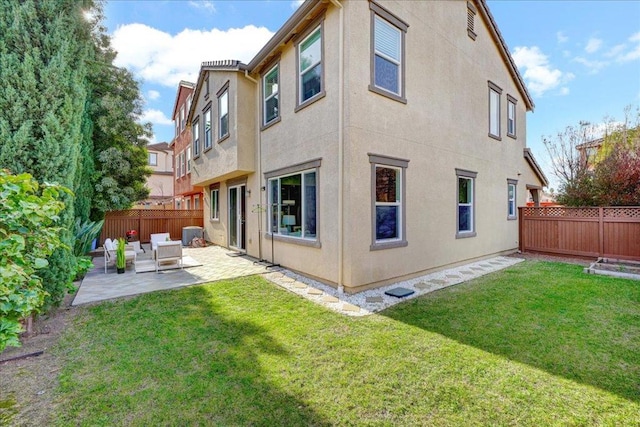 rear view of property featuring a patio area and a lawn