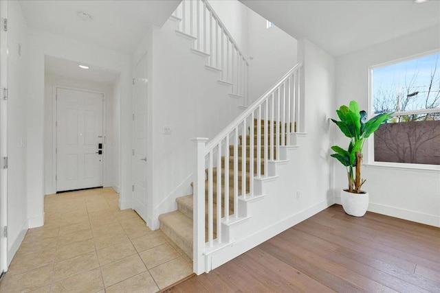 staircase with wood-type flooring