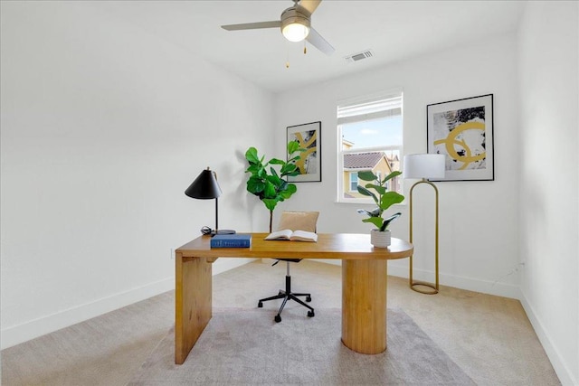 office space featuring light colored carpet and ceiling fan