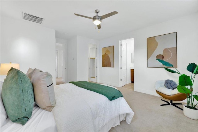 carpeted bedroom featuring ensuite bathroom and ceiling fan