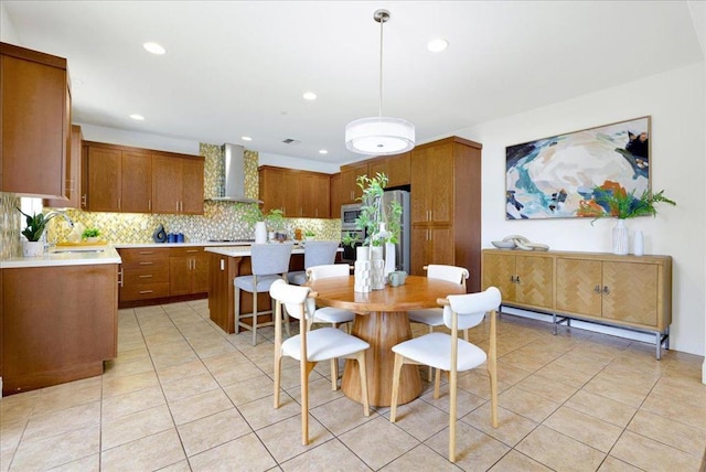 tiled dining space featuring a baseboard heating unit and sink