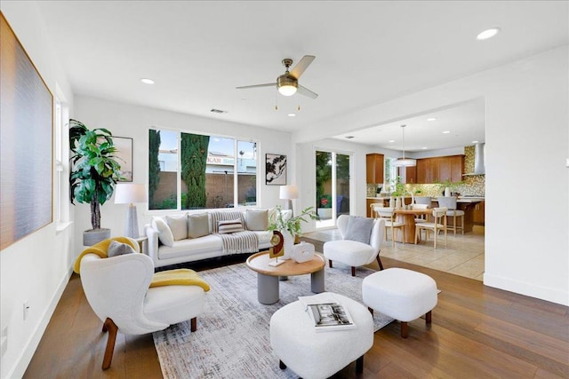 living room featuring hardwood / wood-style flooring and ceiling fan