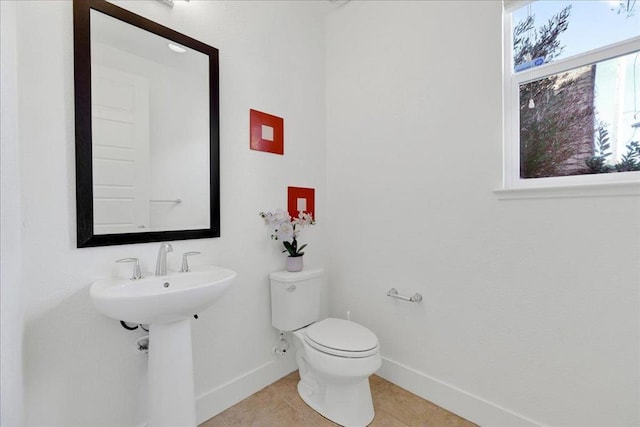 bathroom with tile patterned floors, toilet, and sink