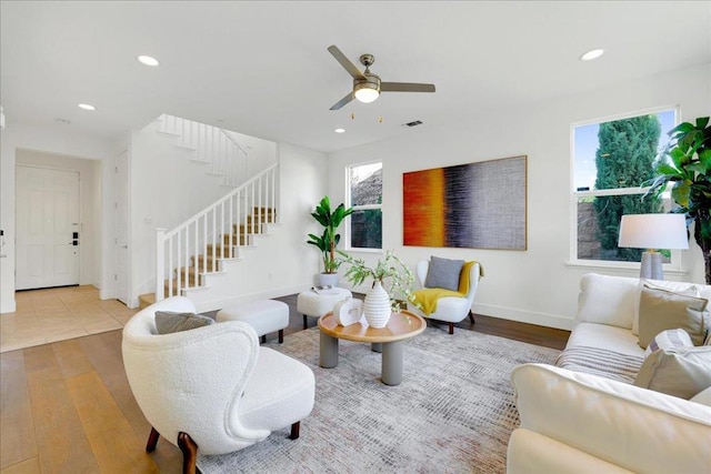 living room featuring ceiling fan and light hardwood / wood-style floors