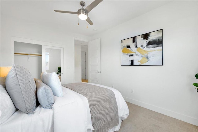 carpeted bedroom with ceiling fan and a closet