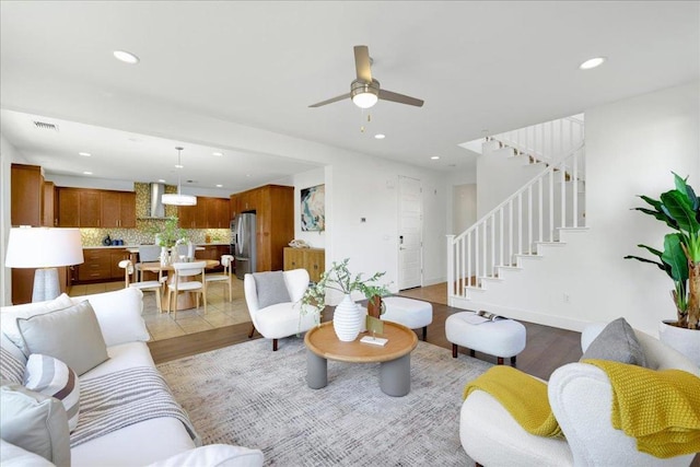 living room featuring ceiling fan and light hardwood / wood-style floors