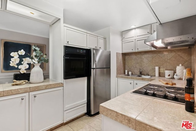 kitchen with white cabinetry, sink, decorative backsplash, exhaust hood, and black appliances