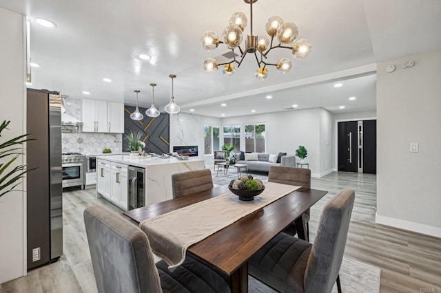 dining space featuring light hardwood / wood-style flooring and beverage cooler