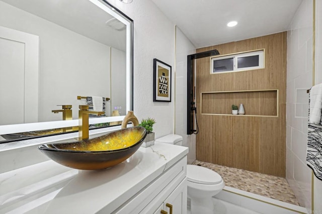 bathroom featuring a stall shower, vanity, toilet, and recessed lighting