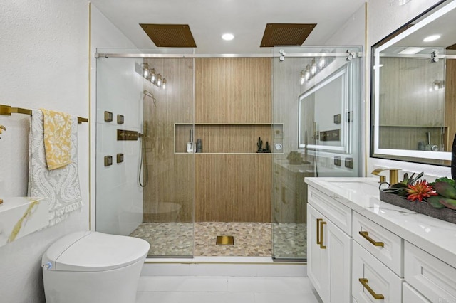 bathroom featuring toilet, a shower stall, and vanity