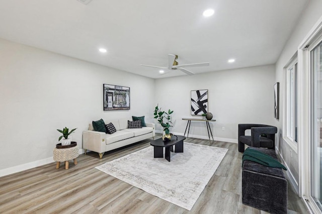 living area featuring recessed lighting, baseboards, and light wood finished floors