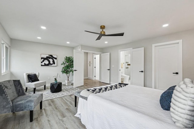 bedroom with light wood finished floors, baseboards, and recessed lighting