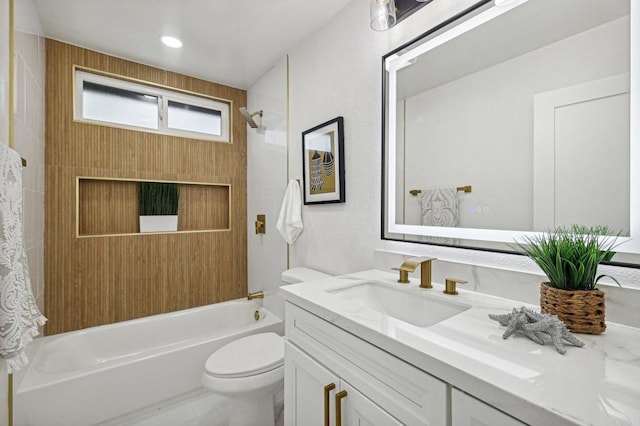 full bathroom featuring washtub / shower combination, vanity, and toilet