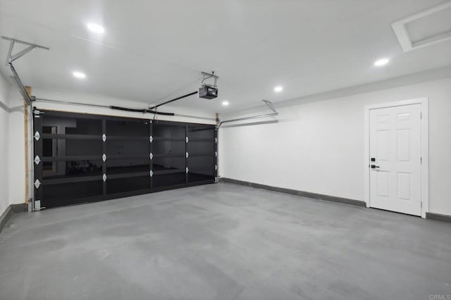 garage featuring recessed lighting, baseboards, and a garage door opener