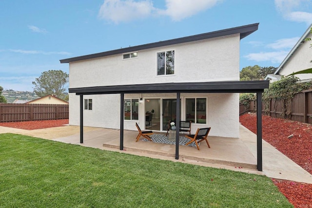 back of house featuring a patio area, a fenced backyard, and stucco siding