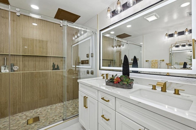 full bathroom with double vanity, a sink, and a shower stall