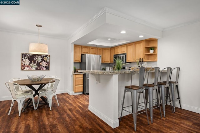 kitchen with a kitchen breakfast bar, dark wood-type flooring, stainless steel appliances, and kitchen peninsula