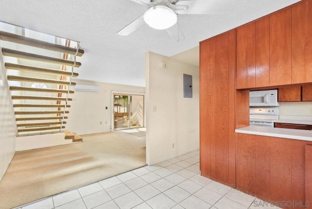 kitchen featuring light tile patterned floors, white appliances, a wall unit AC, and electric panel