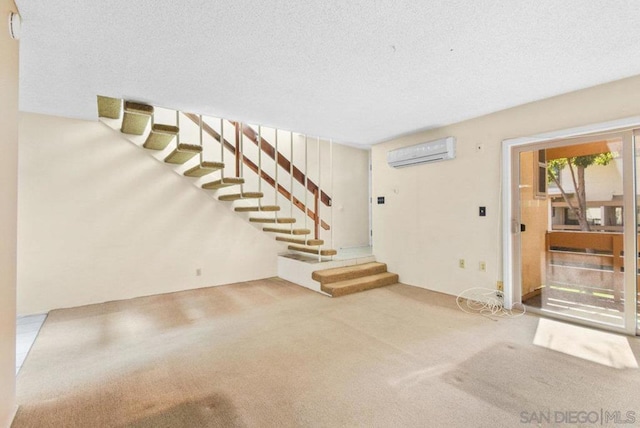 unfurnished living room featuring carpet, a wall unit AC, and a textured ceiling