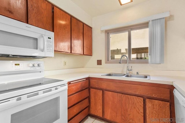 kitchen featuring sink and white appliances